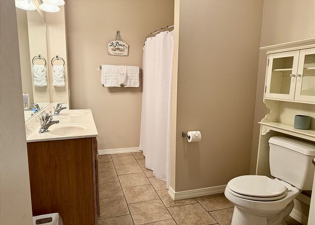 Guest bathroom with tub and shower in Condo A-4