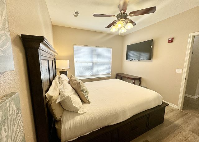 Queen bedroom with television in Condo A-4