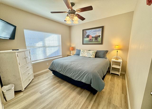Queen bedroom with television in Condo A-4