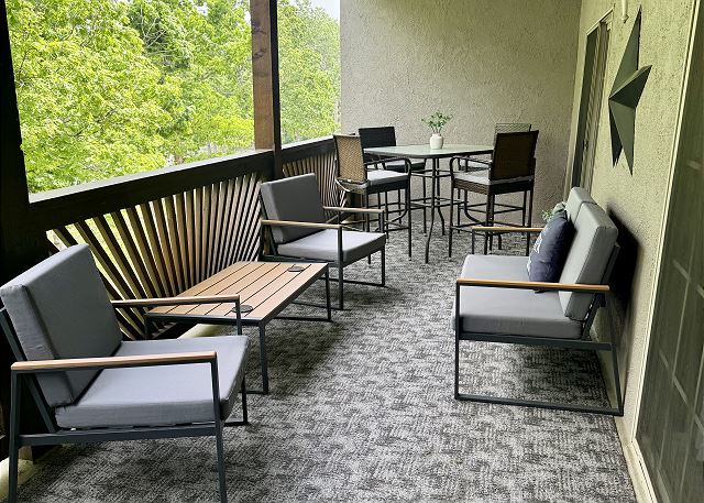 Covered private deck with dining and seating at Condo A-5