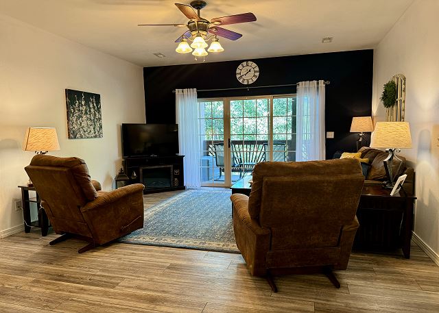 Living room and private covered deck inside Condo A-5 at Vickery Resort