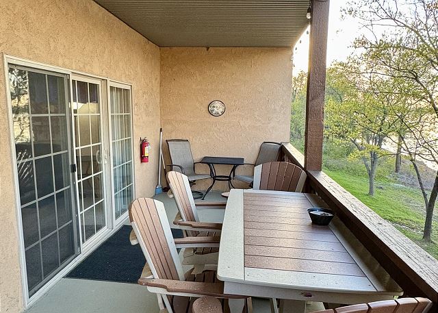 Covered balcony seating and lake view at Condo A-6