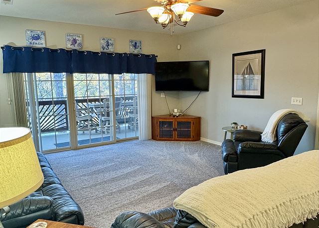 Living room with balcony access in Condo A-6