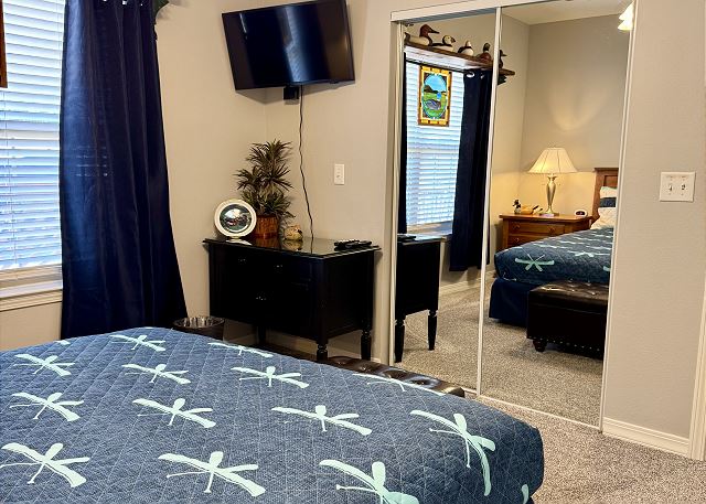 Queen bedroom with television in Condo A-6