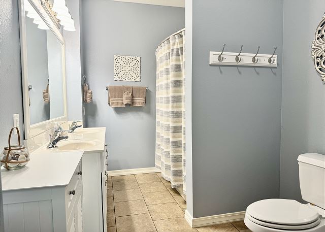 Guest bathroom with tub and shower in Condo A-7