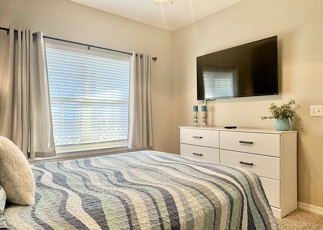 Queen bedroom with television in Condo A-7