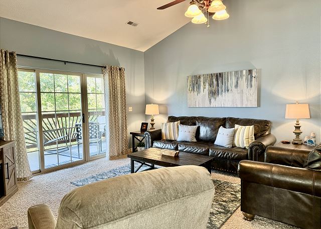 Living room with balcony access in Condo A-7