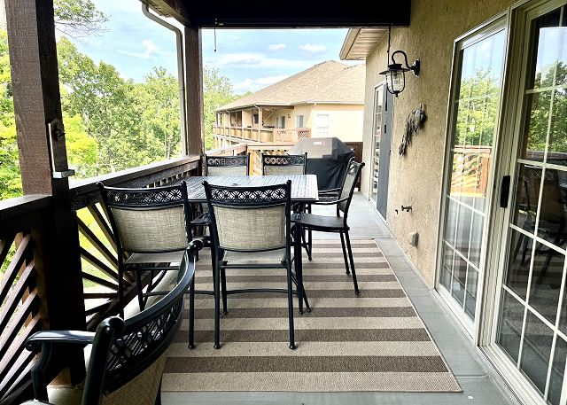 Covered deck dining and seating at Condo A-9