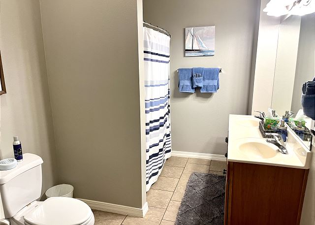 Guest bathroom with tub and shower in Condo A-9