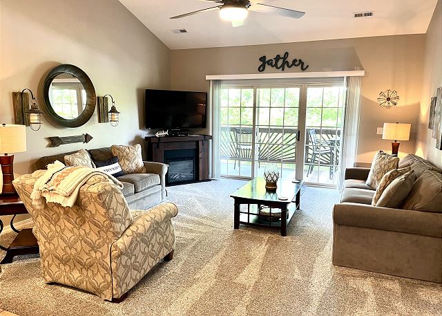 Condo A-9 living room with fireplace and deck access