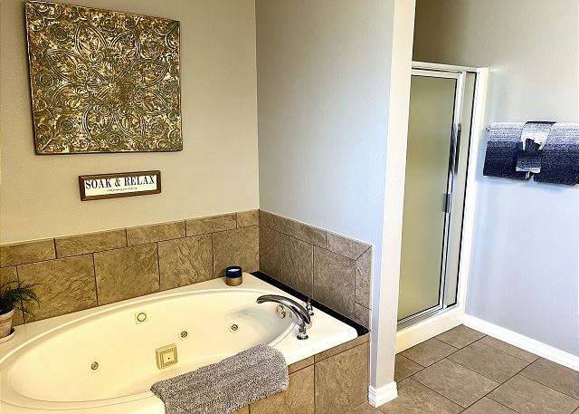 Primary bathroom with jetted tub and shower in Condo A-9