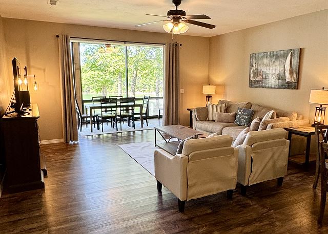 Renovated living room opening to the screened patio in Condo B-1