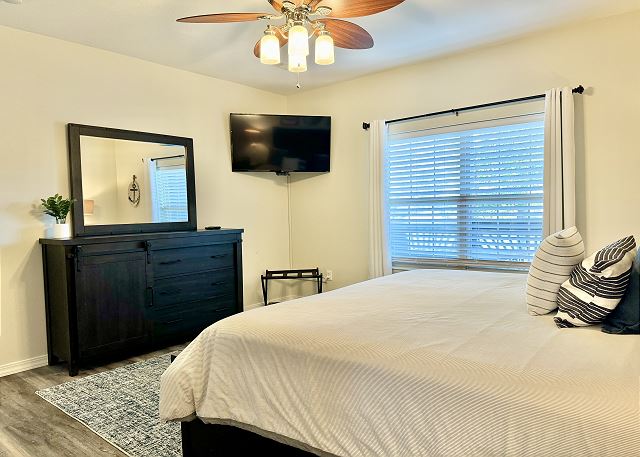 Primary king bedroom with TV