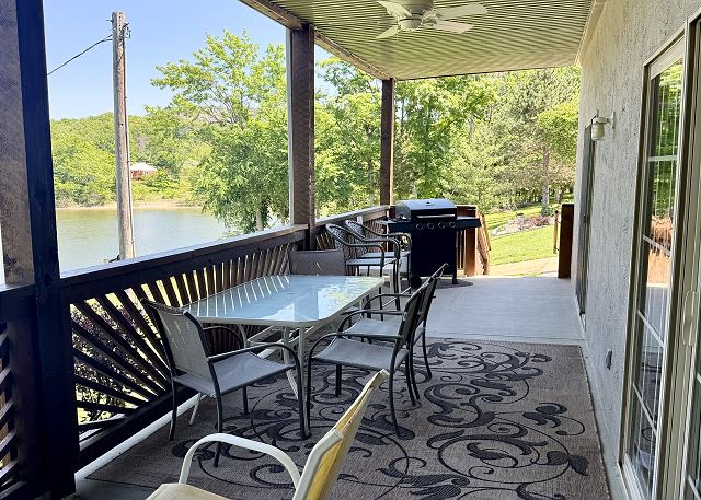 Covered deck dining area overlooking Table Rock Lake at Condo B-3