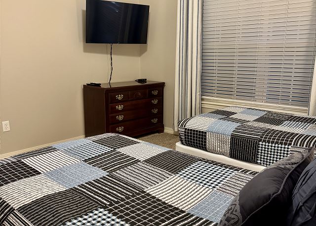 Twin bedroom with television