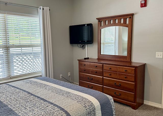 Secondary king bedroom with television and deck access in Condo B-4