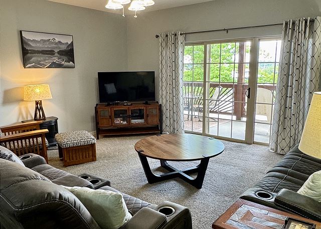 Condo B-4 living room with fireplace and television