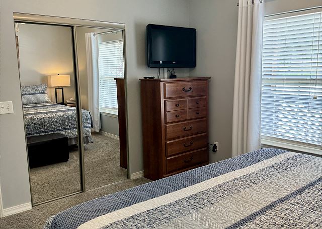 Queen bedroom with television in Condo B-4