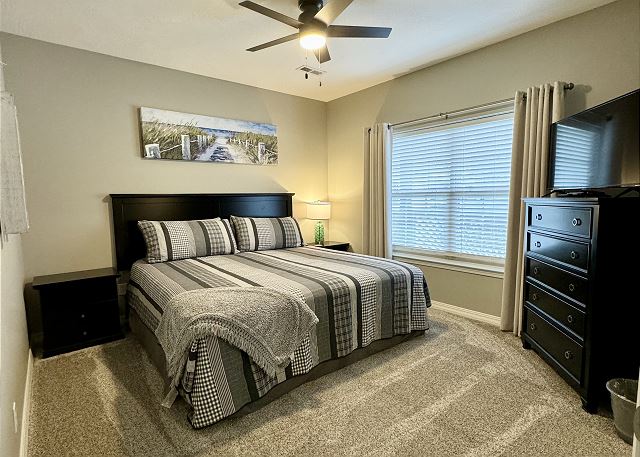 First king bedroom with television