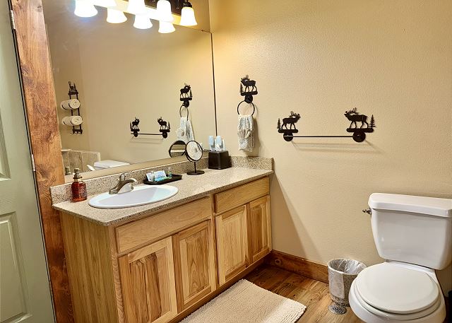 Primary bathroom tub shower and vanity in Condo B-8