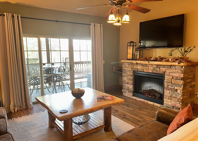 Condo B-8 living room with fireplace and deck access