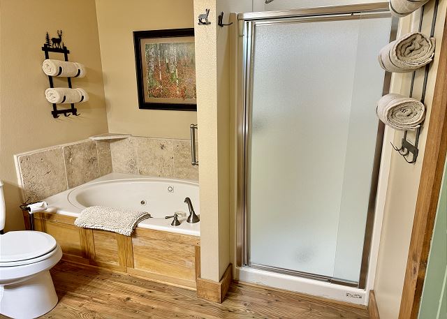 Primary bathroom with jetted tub and shower in Condo B-8