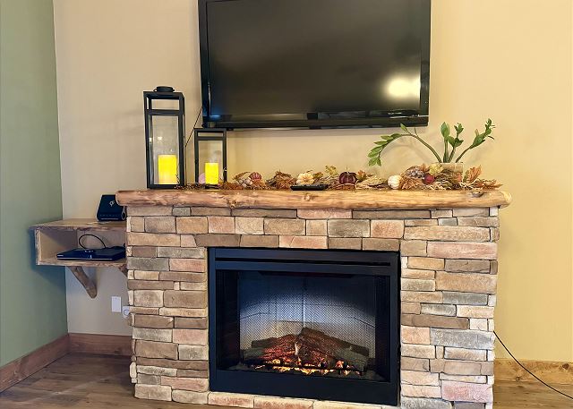 Living room fireplace and television in Condo B-8